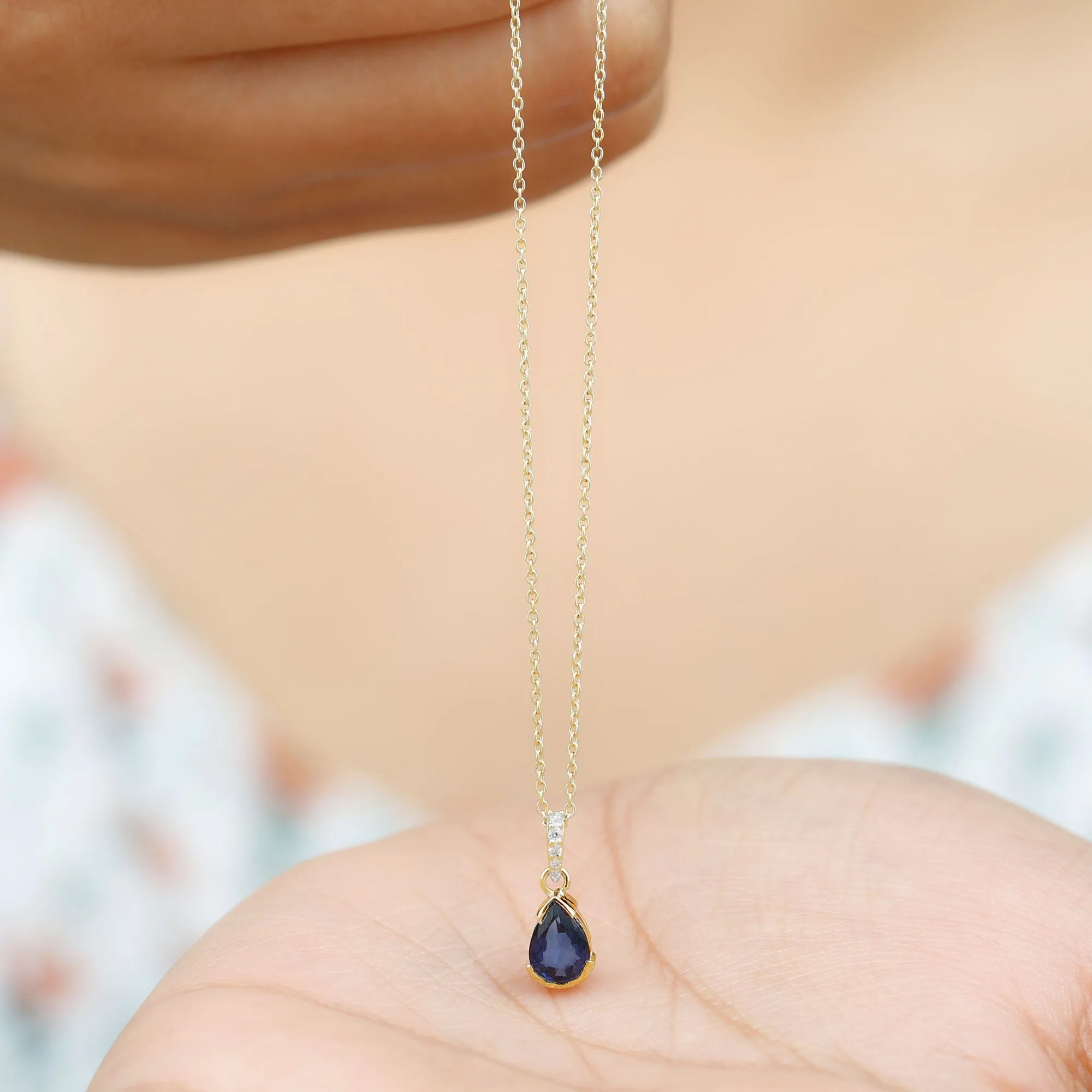 1 CT Pear Cut Blue Sapphire Solitaire Pendant in Half Bezel Setting with Diamond Accent Bail